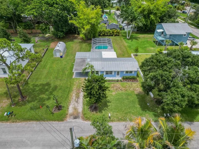an aerial view of a house with outdoor space pool seating area and yard