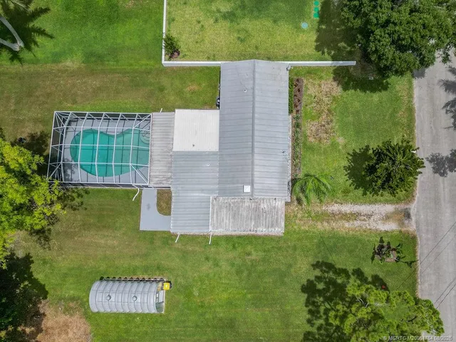 an aerial view of a house with a yard