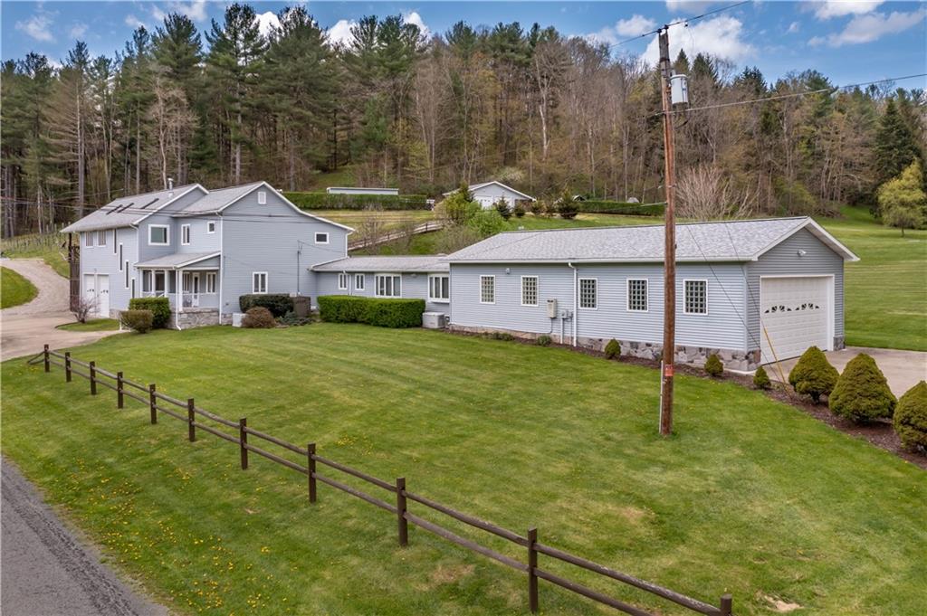 527 Claylick Road Holbrook, PA 15341 - Photo 1 of 24 a view of a white house with a yard table and chairs