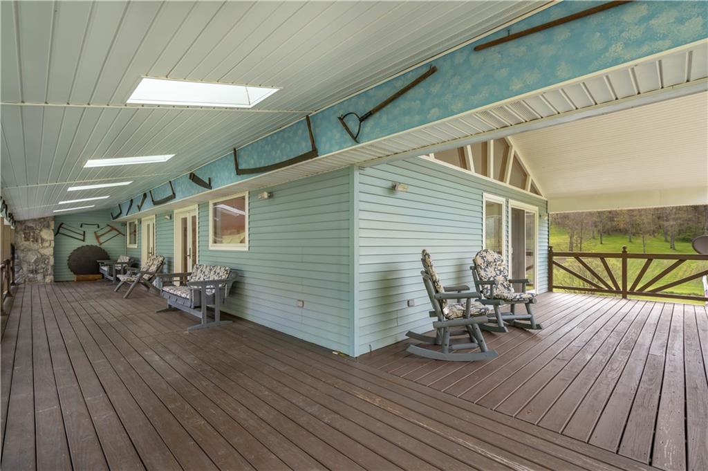 527 Claylick Road Holbrook, PA 15341 - Photo 5 of 24 a view of a patio with table and chairs and wooden floor