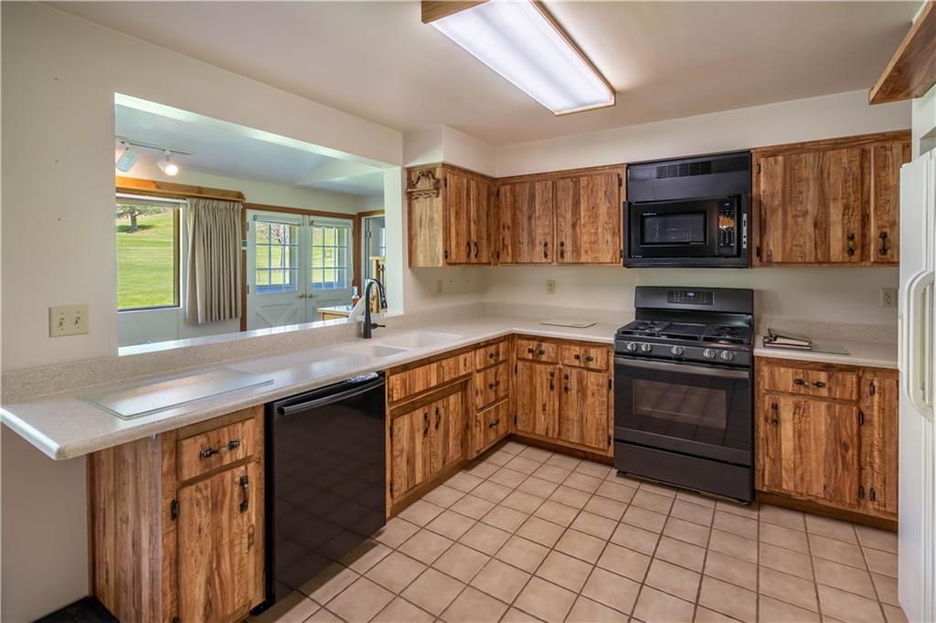 527 Claylick Road Holbrook, PA 15341 - Photo 10 of 24 a kitchen with stainless steel appliances granite countertop a stove a sink and a microwave