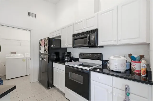 a bathroom with a granite countertop sink a toilet and a shower
