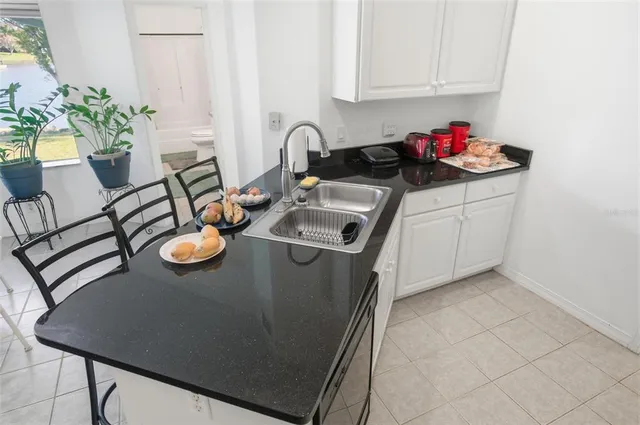 an aerial view of a house with outdoor space and lake view