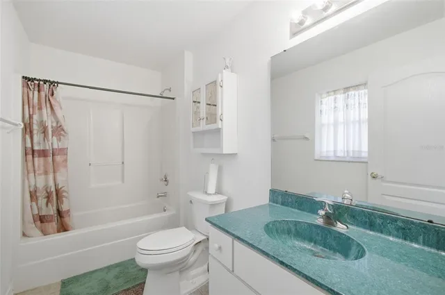 an aerial view of a house with a yard and trees