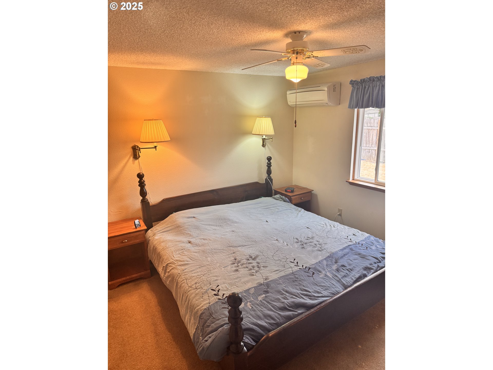560 Maple Street Aumsville, OR 97325 - Photo 2 of 12 a bedroom with a bed and a chandelier