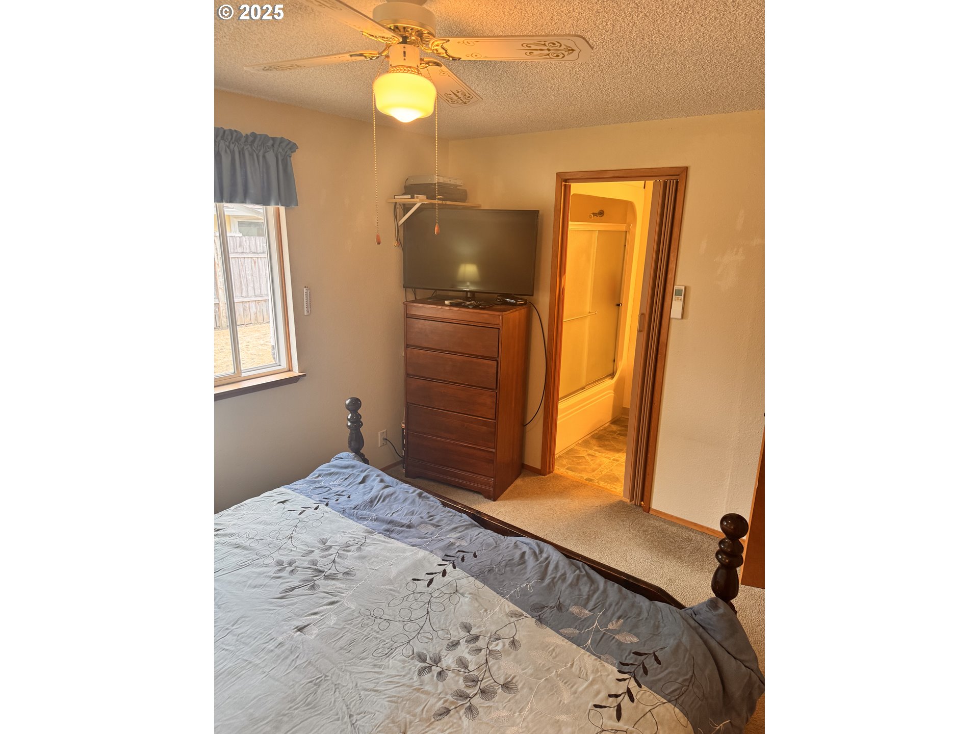 560 Maple Street Aumsville, OR 97325 - Photo 3 of 12 a bedroom with a bed and wooden floor
