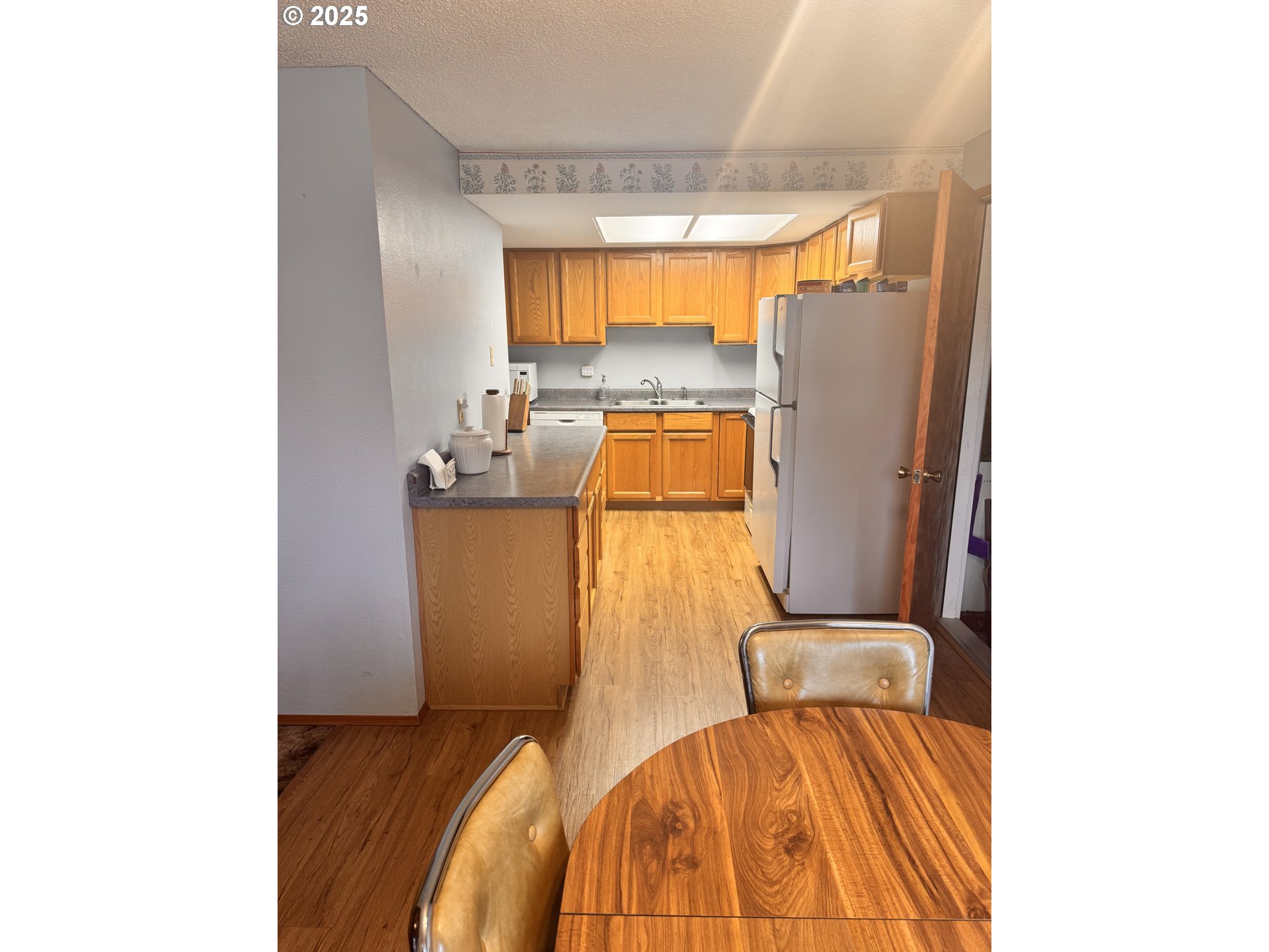560 Maple Street Aumsville, OR 97325 - Photo 9 of 12 a bedroom with a bed and wooden floor