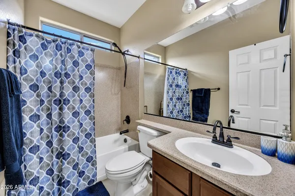 a bathroom with a sink and mirror with toilet