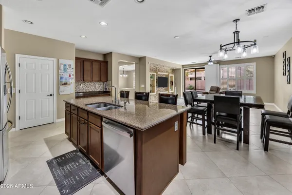 a kitchen with center island table and chairs