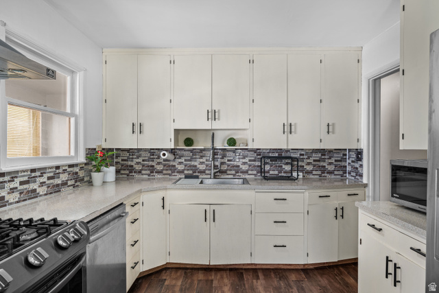 88 East C Street Springville, UT 84663 - Photo 11 of 32 White cabinetry paired with a mosaic tile backsplash and light-toned countertops