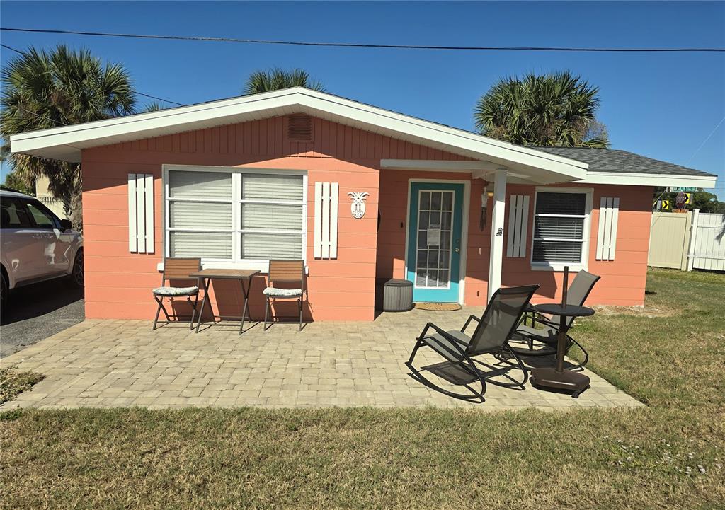 470 South McCall Road, Unit 11 Englewood, FL 34223 - Photo 1 of 22 a view of a patio with table and chairs potted plants and floor to ceiling window