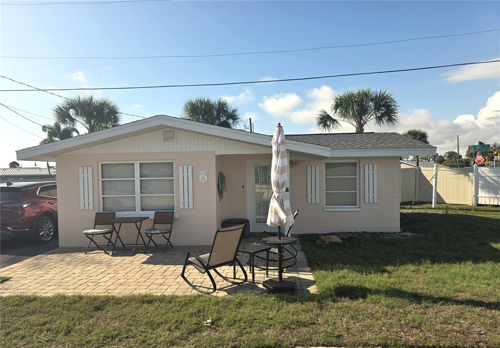 a backyard of a house with yard fire pit and chairs