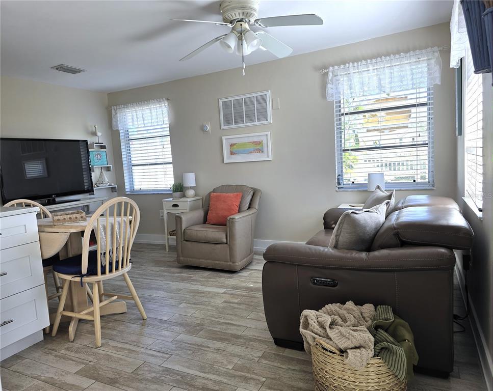 470 South McCall Road, Unit 11 Englewood, FL 34223 - Photo 12 of 22 a living room with furniture and a flat screen tv