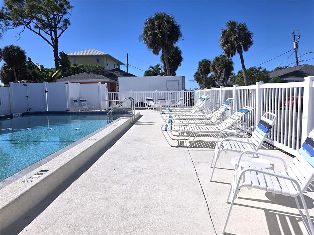 470 South McCall Road, Unit 11 Englewood, FL 34223 - Photo 19 of 22 a view of a patio with barbeque grill and potted plants