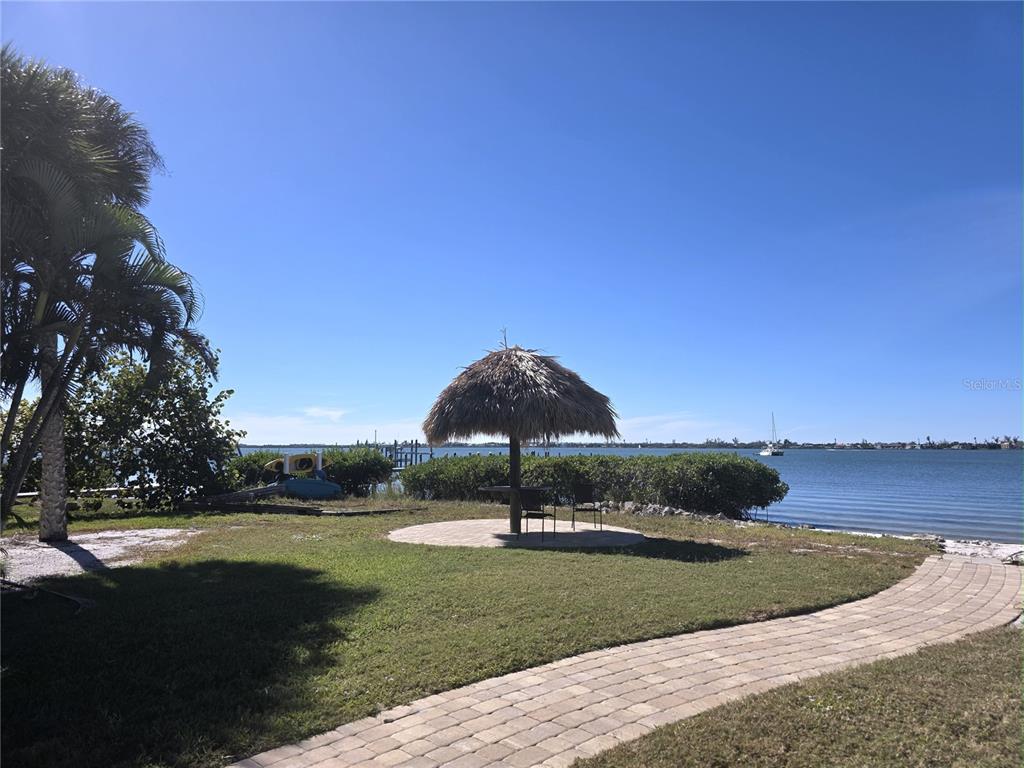 470 South McCall Road, Unit 11 Englewood, FL 34223 - Photo 5 of 22 a house view with a garden space