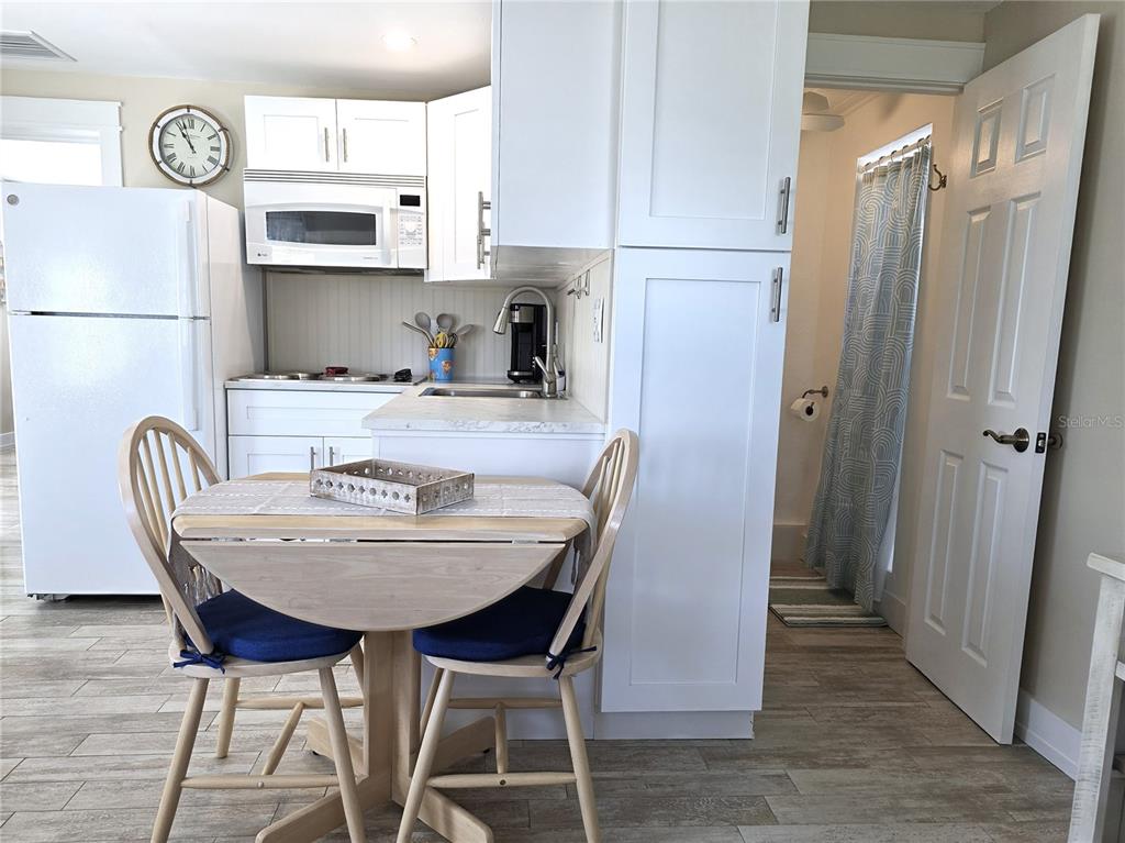 470 South McCall Road, Unit 11 Englewood, FL 34223 - Photo 7 of 22 a dining room with furniture and wooden floor