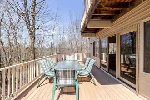 a view of a chairs and table in the balcony