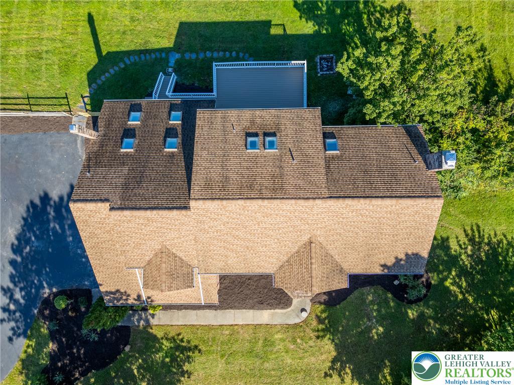 630 Clearfield Road Nazareth, PA 18064 - Photo 6 of 100 An aerial perspective showcases a shingled roofline equipped with multiple skylights.