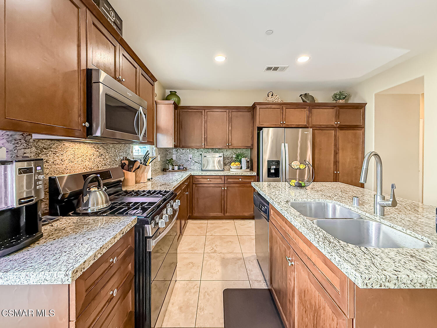 2968 Royal Avenue Simi Valley, CA 93065 - Photo 12 of 45 a kitchen with stainless steel appliances granite countertop a sink stove and refrigerator