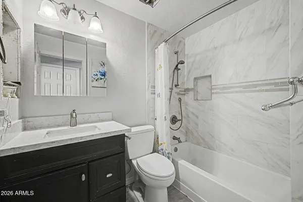 a dining room with furniture and a kitchen view