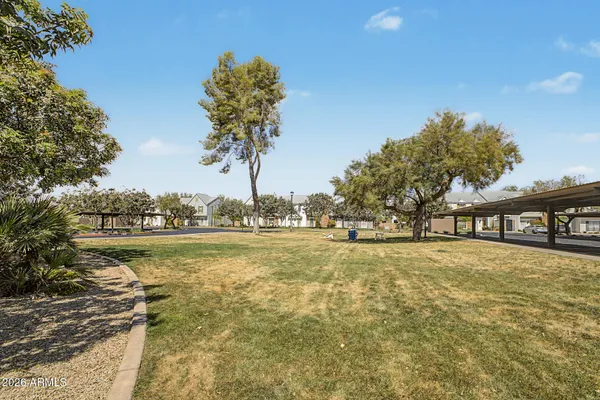 a bedroom with a bed a chandelier and a window