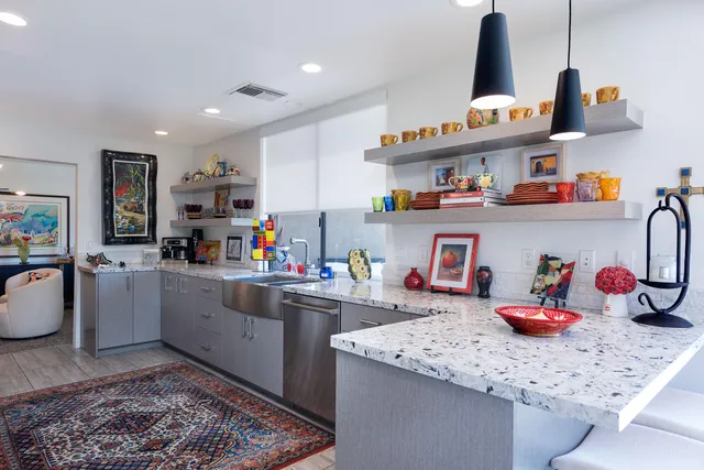 a kitchen with lots of clutter and cabinets