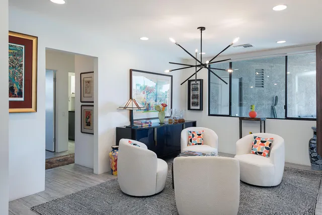 a living room with furniture and a chandelier