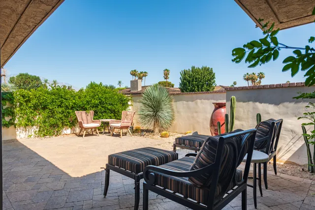 a view of a chairs and table in patio