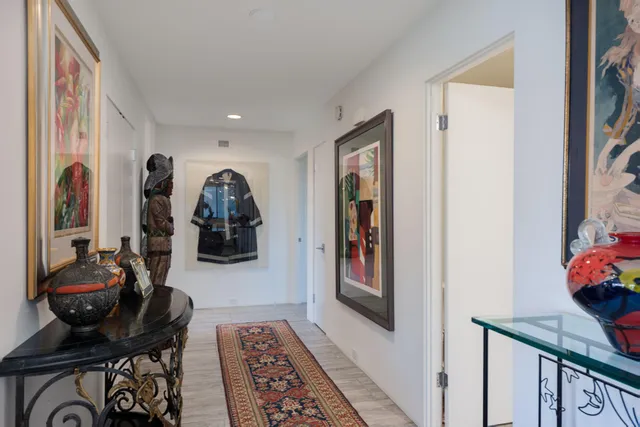 a view of a hallway with furniture and closet