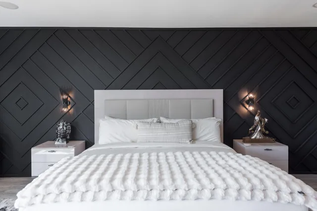 a bedroom with a bed and a night stand