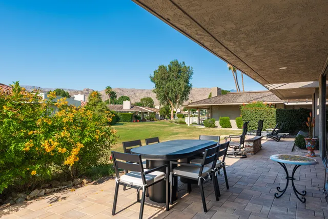 a view of outdoor sitting area with swimming pool and furniture