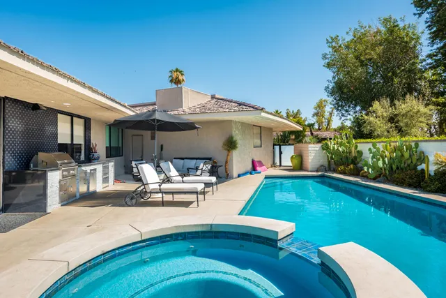 a living room with furniture and a chair