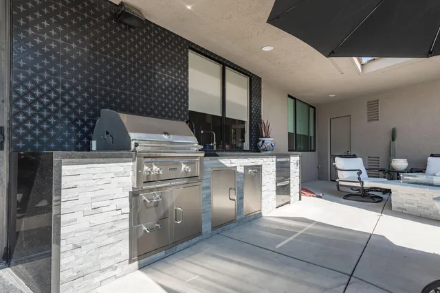 a view of a chairs and table in backyard