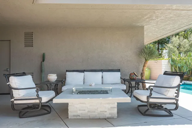 a view of a house with swimming pool and sitting area