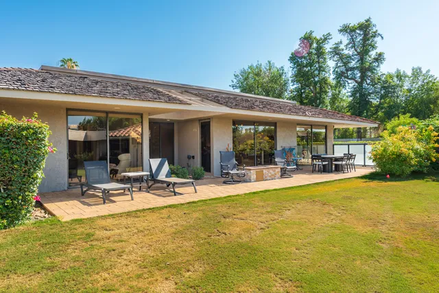 a view of a swimming pool with an outdoor seating