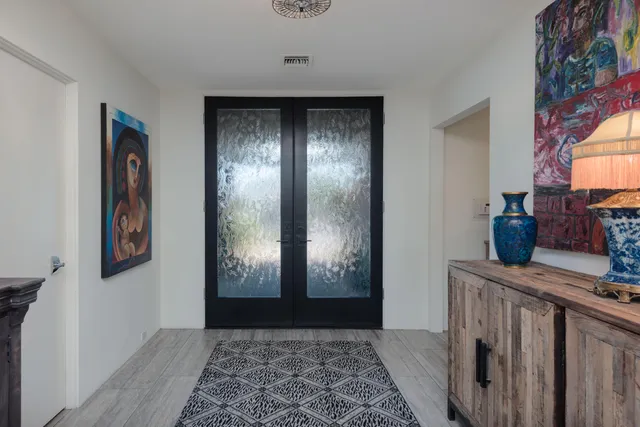 a view of a hallway with wooden floor and a fireplace