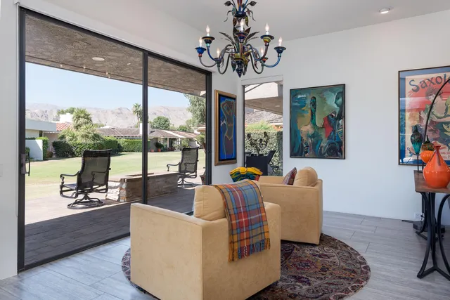 a living room with furniture large window and a flat screen tv