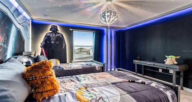 a bedroom with a bed and a chandelier