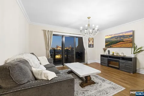 a living room with furniture and a chandelier