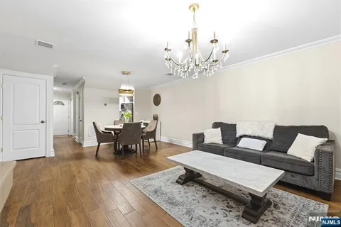 a living room with furniture and a chandelier
