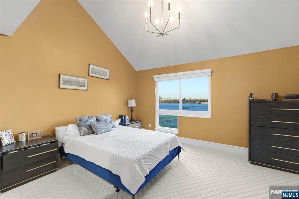 101 Highway 5, Unit 304 Edgewater, NJ 07020 - Photo 15 of 24 a bedroom with a bed and a dresser