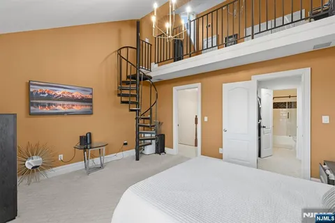 a bedroom with a bed and a chandelier