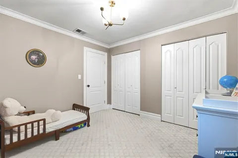 a spacious bedroom with a bed and a window