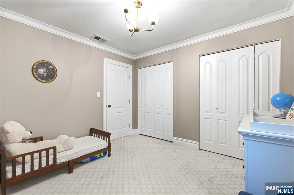 101 Highway 5, Unit 304 Edgewater, NJ 07020 - Photo 23 of 24 a spacious bedroom with a bed and a window