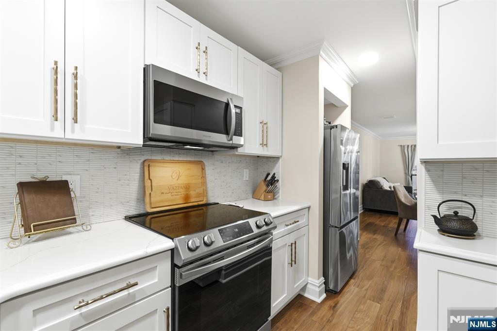 101 Highway 5, Unit 304 Edgewater, NJ 07020 - Photo 6 of 24 a kitchen with a stove and a microwave