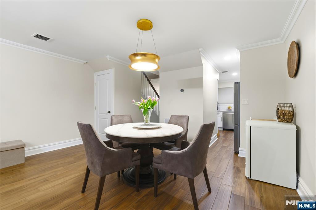 101 Highway 5, Unit 304 Edgewater, NJ 07020 - Photo 8 of 24 a view of a dining room with furniture and wooden floor