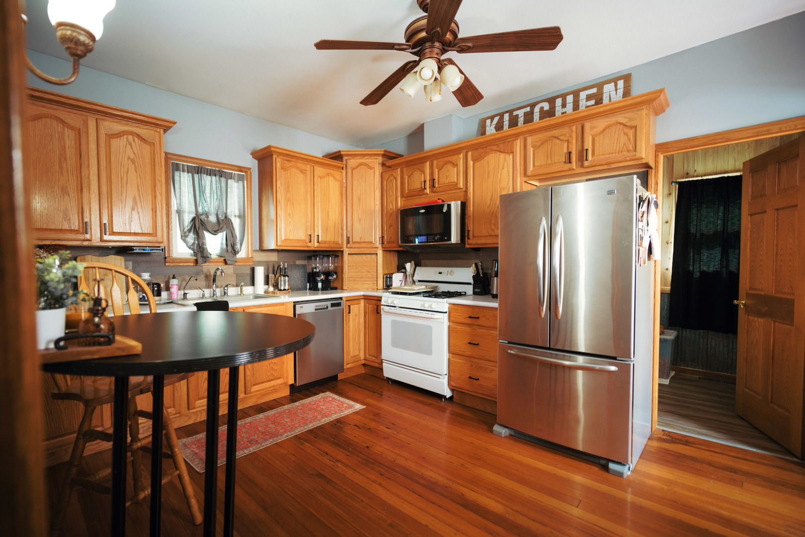 3915 East 758th Road Triumph, IL 61371 - Photo 6 of 15 a kitchen with granite countertop a refrigerator a sink appliances and cabinets