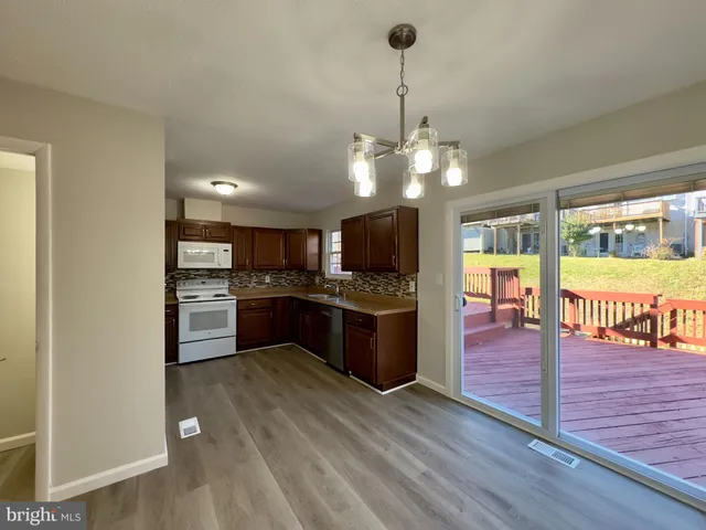 a large kitchen with a center island and stainless steel appliances