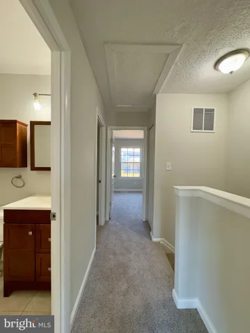 a view of a bathroom with sink and mirror