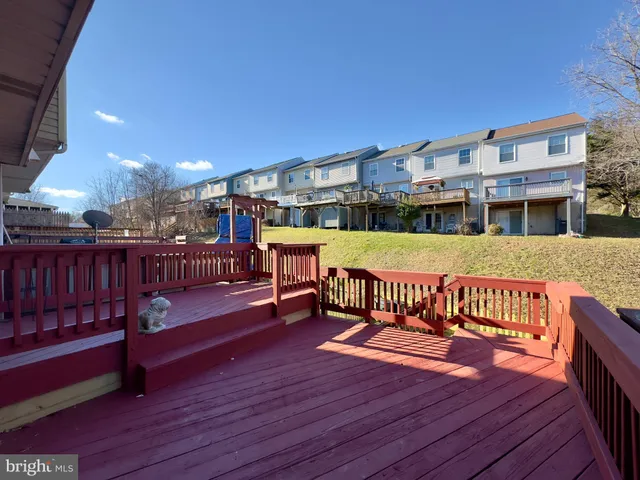 a view of a roof deck with wooden floor and fence